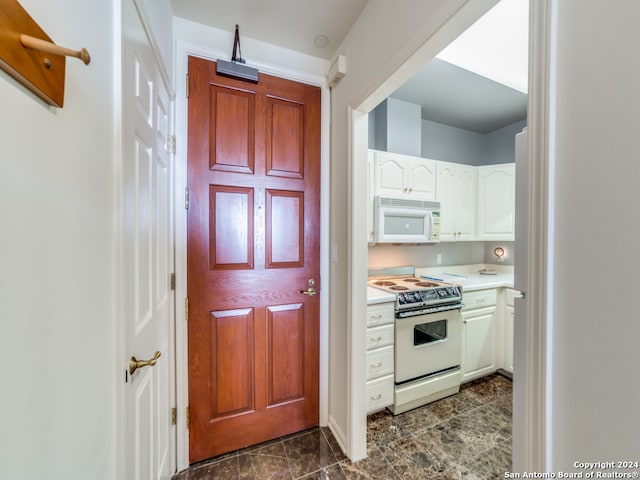 kitchen with white appliances and white cabinetry