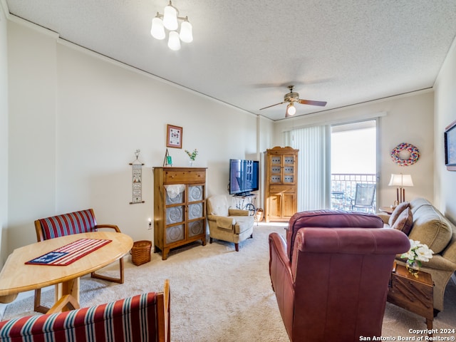 carpeted living room featuring ceiling fan with notable chandelier and a textured ceiling