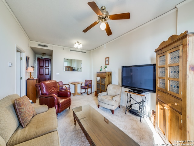 carpeted living room with ornamental molding and ceiling fan