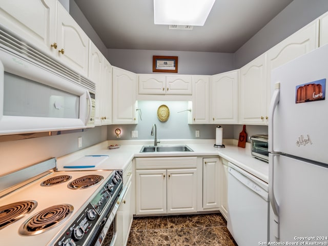 kitchen featuring white appliances, white cabinetry, and sink