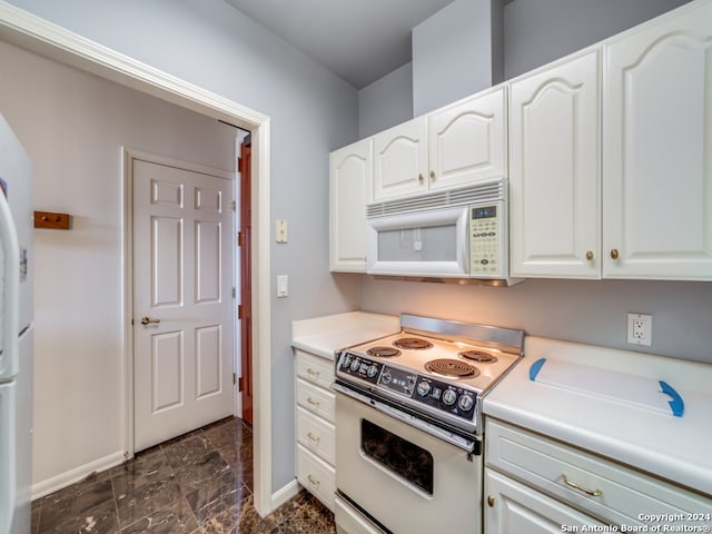 kitchen with white appliances and white cabinetry