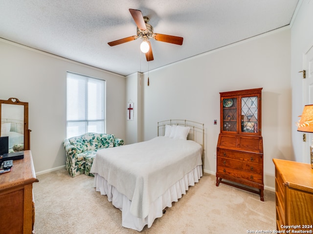 carpeted bedroom with a textured ceiling and ceiling fan