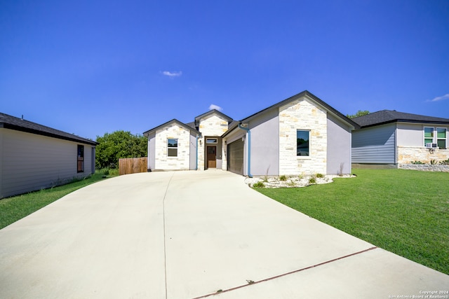 view of front of home featuring a garage and a front lawn