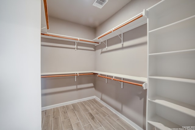 spacious closet with light hardwood / wood-style floors