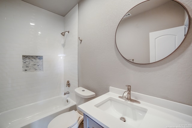 full bathroom featuring vanity, toilet, and tiled shower / bath