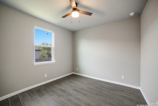 empty room featuring ceiling fan and dark hardwood / wood-style floors