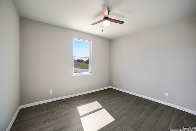 unfurnished room featuring ceiling fan and dark hardwood / wood-style floors