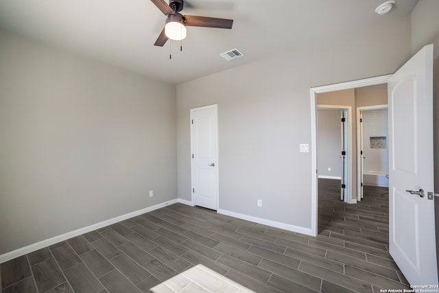 unfurnished bedroom featuring ceiling fan and dark wood-type flooring