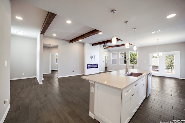 kitchen with dishwasher, a center island with sink, sink, beamed ceiling, and dark hardwood / wood-style flooring