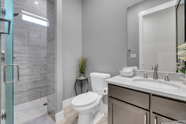 bathroom with tile patterned flooring, vanity, toilet, and a shower with shower door