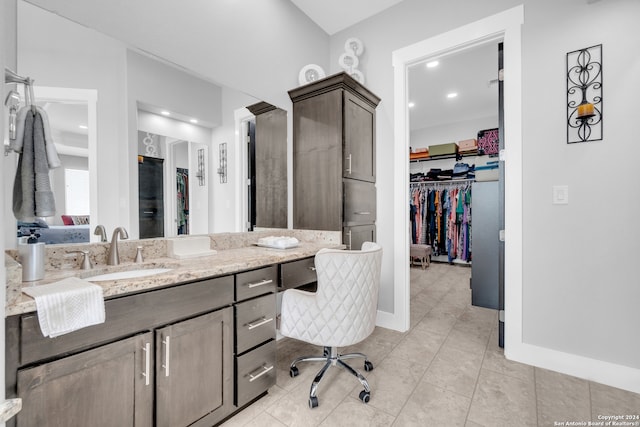 bathroom featuring tile patterned flooring and vanity