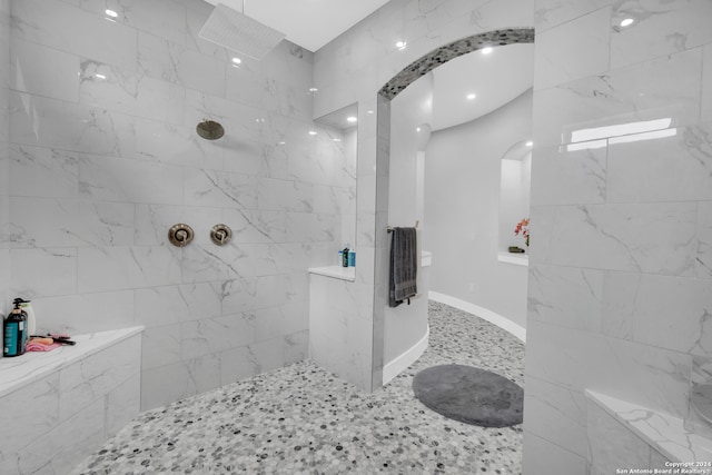 bathroom featuring heating unit and tiled shower