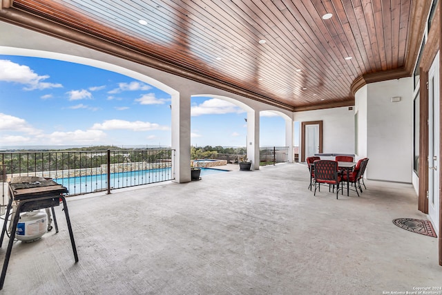 view of patio / terrace with a fenced in pool