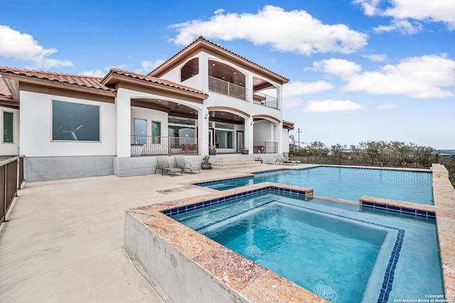 view of swimming pool with a patio and an in ground hot tub