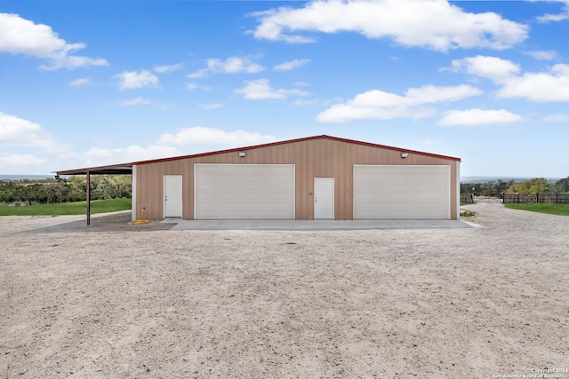 garage featuring wood walls and a carport