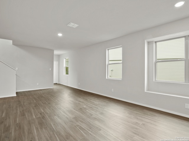 spare room with hardwood / wood-style floors and a wealth of natural light