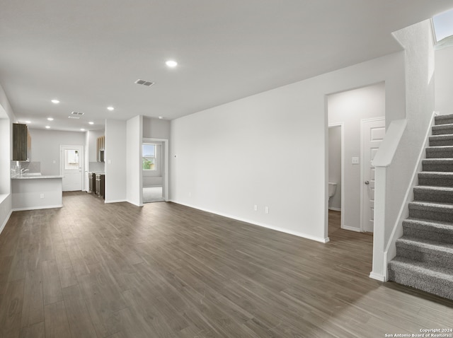 unfurnished living room featuring dark wood-type flooring