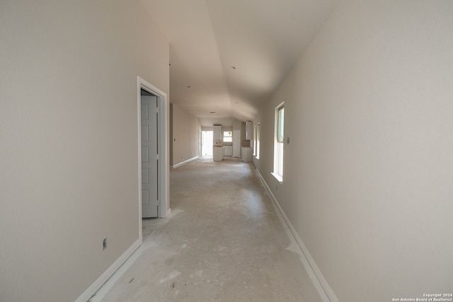 hallway with lofted ceiling