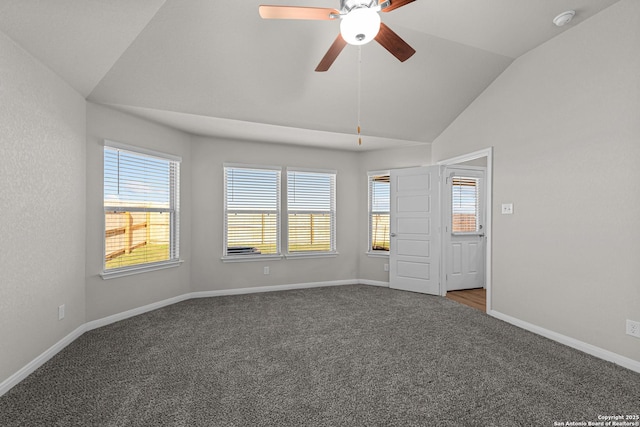 spare room featuring carpet, ceiling fan, a healthy amount of sunlight, and vaulted ceiling