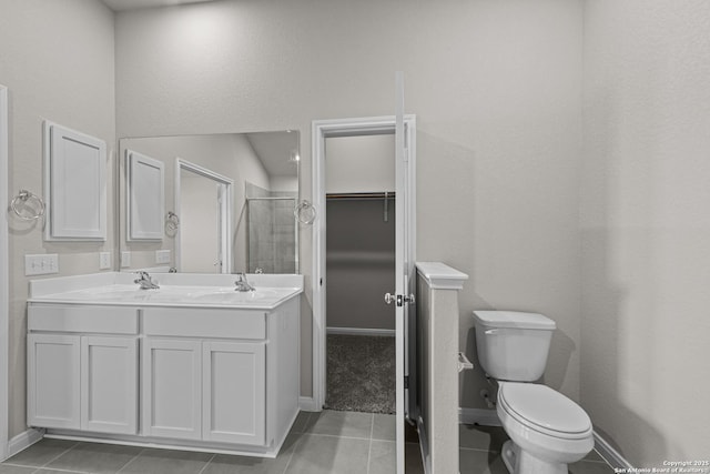 bathroom with tile patterned flooring, vanity, toilet, and an enclosed shower