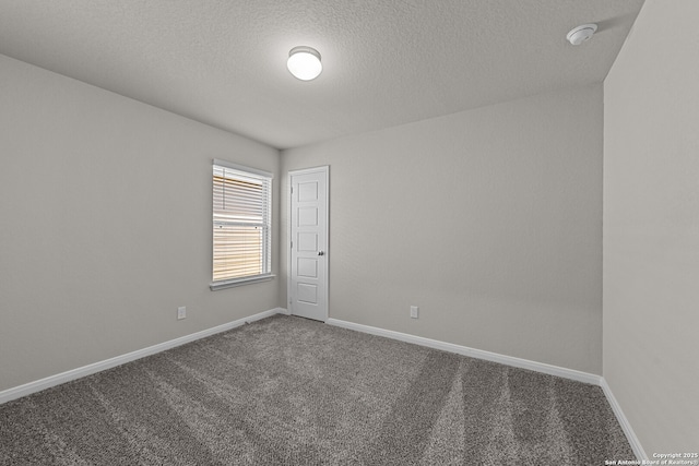 carpeted spare room featuring a textured ceiling