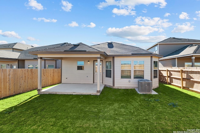 rear view of property with a lawn, a patio area, and central air condition unit