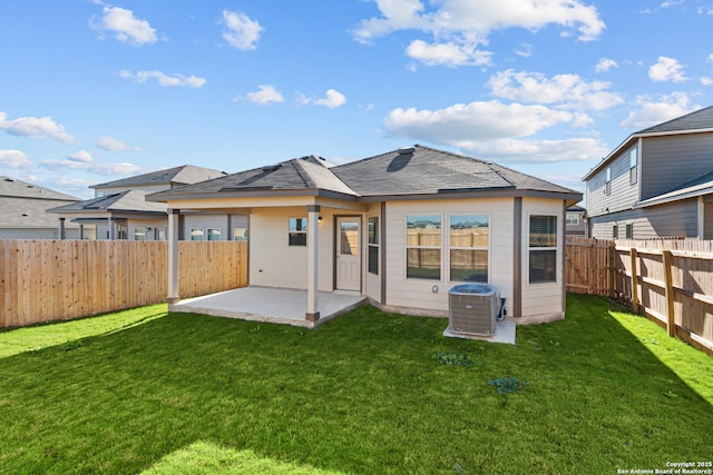 rear view of house featuring central air condition unit, a yard, and a patio