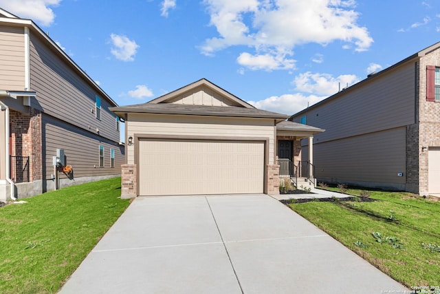 view of front of home with a front yard and a garage