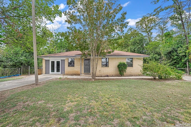 single story home with french doors and a front yard