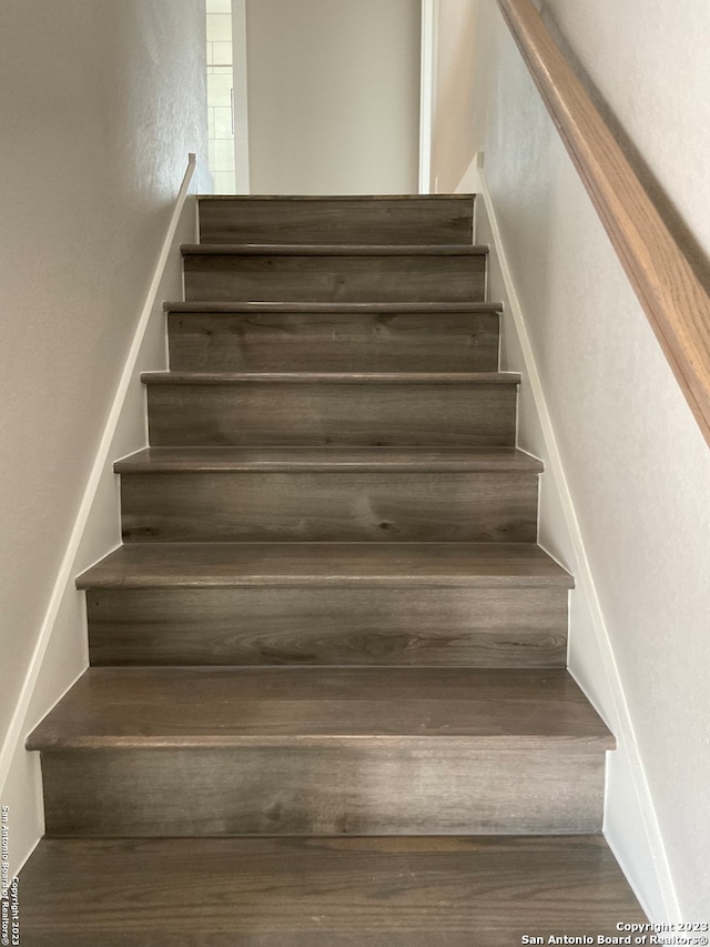 stairs featuring wood-type flooring