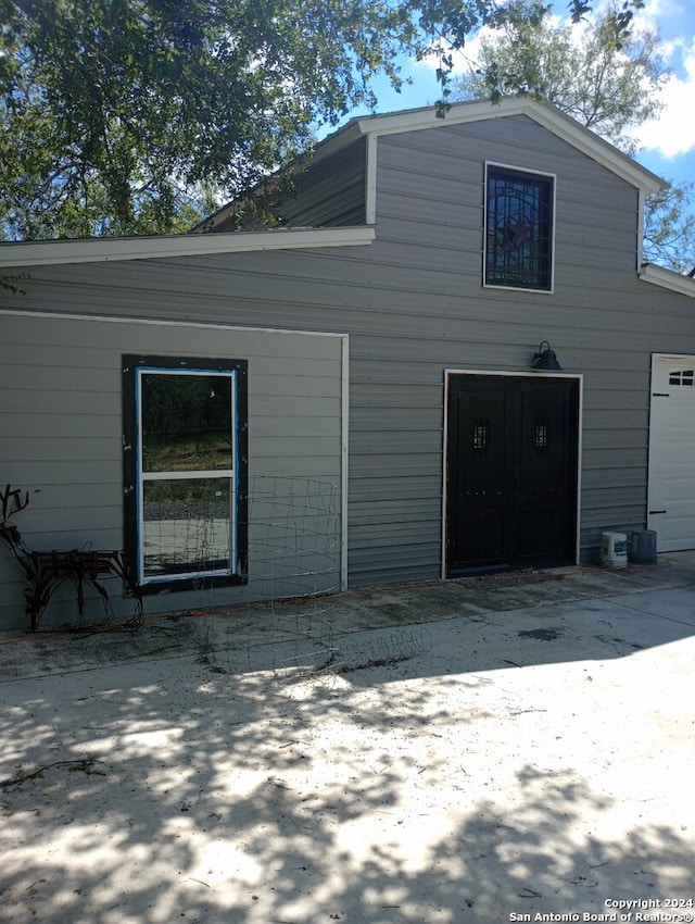 rear view of house featuring a garage