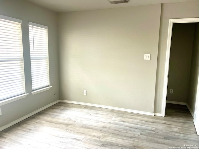 unfurnished room with light hardwood / wood-style flooring