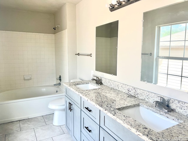 full bathroom featuring vanity, tiled shower / bath combo, toilet, and tile patterned flooring