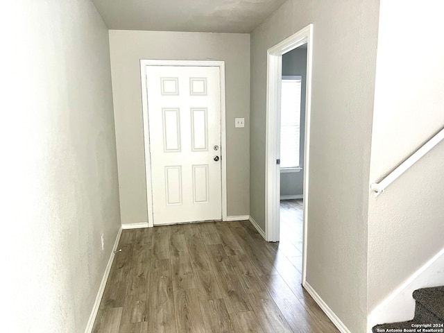 corridor with hardwood / wood-style flooring