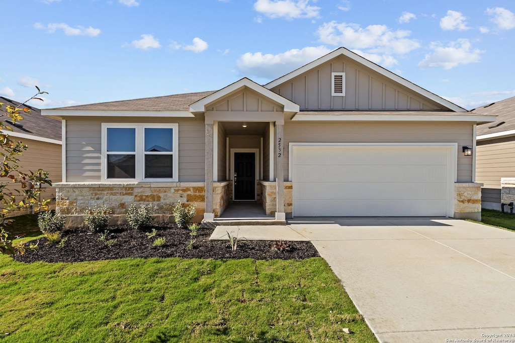 2532 Solon Ln, Seguin, TX 78155 - view of front of house featuring a garage, stone siding, board and batten siding, and concrete driveway