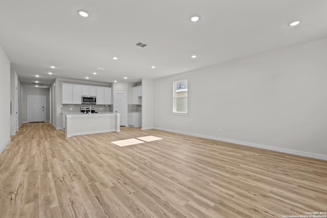 unfurnished living room featuring light wood-type flooring