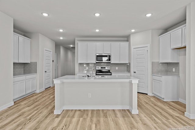 kitchen featuring white cabinetry, a kitchen island with sink, and appliances with stainless steel finishes