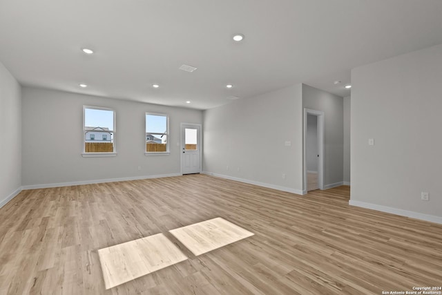 empty room with light hardwood / wood-style flooring