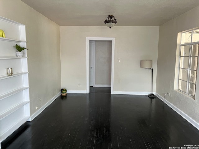 spare room with dark hardwood / wood-style floors