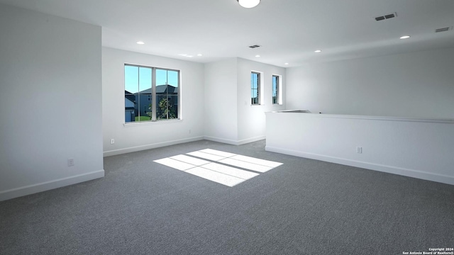 unfurnished room with dark carpet