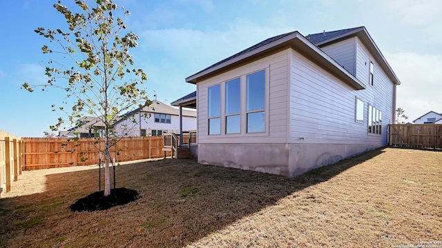 view of side of property with a yard