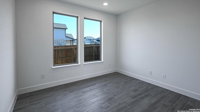 unfurnished room featuring dark hardwood / wood-style floors