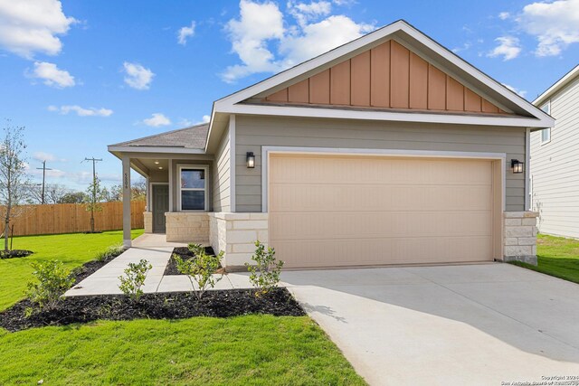 view of front of house with a garage and a yard