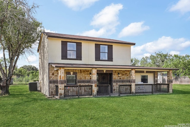 back of house featuring central AC and a yard