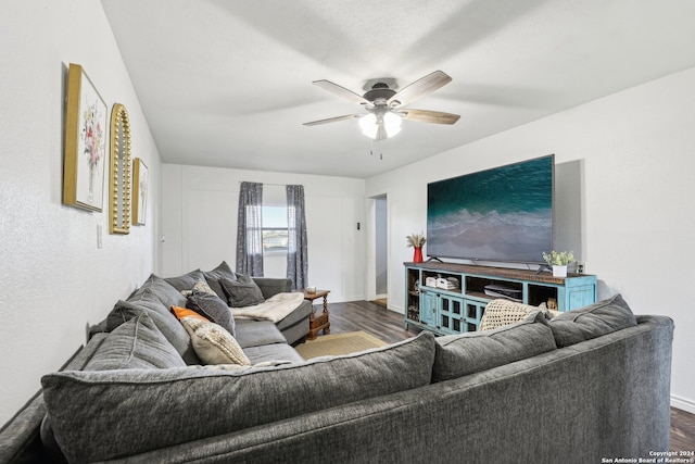 living room with ceiling fan and dark hardwood / wood-style floors