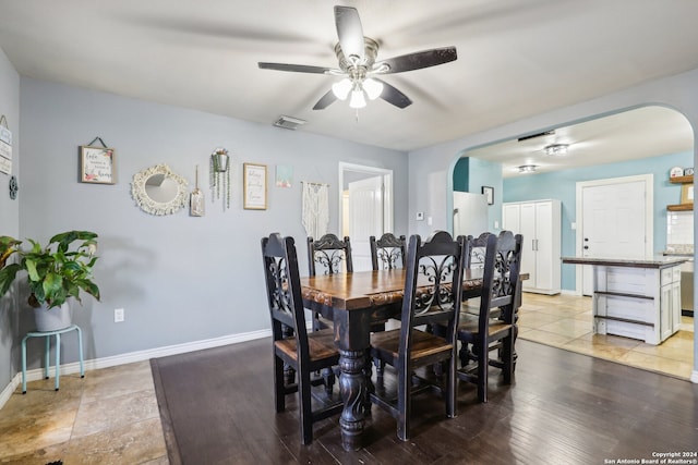 dining area with light hardwood / wood-style flooring and ceiling fan