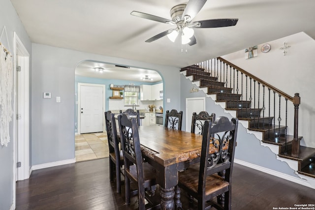 dining area with wood-type flooring and ceiling fan