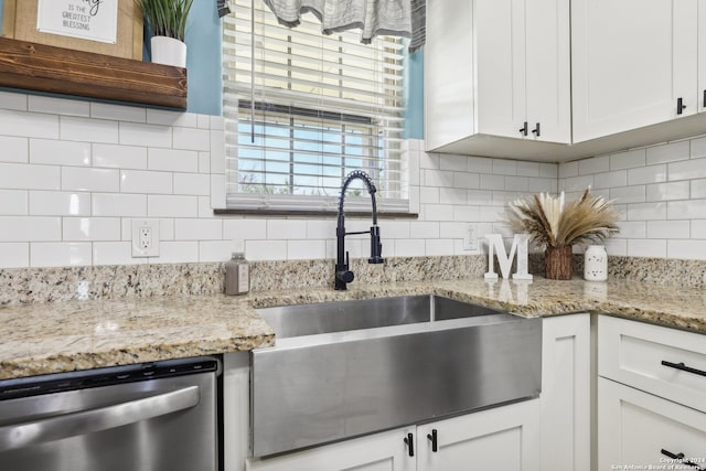 kitchen with white cabinets, dishwasher, sink, and tasteful backsplash