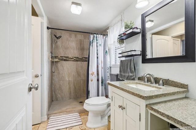 bathroom featuring toilet, vanity, a shower with shower curtain, and tile patterned floors