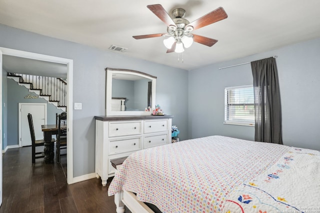 bedroom with dark hardwood / wood-style floors and ceiling fan